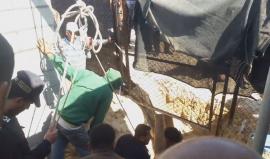 مشهد أثناء انتشال قوات الدفاع المدني والشرطة البحرية شاب بعد انهيار بئر عليه أثناء فحره على شاطئ بحر رفح جنوب قطاع غزة.