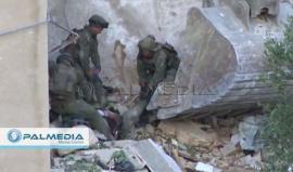 مشاهد من تفجير المنزل الذي تحصن فيه الشهيد محمد الفقيه في بلدة صوريف بالخليل والاشتباكات المسلحة التي دارت في المكان وانتشال الجثمان عقب هدم المنزل وقصفه بالصواريخ