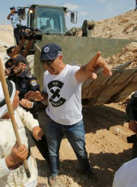 Palestinian man argues with Israeli troops as they protest against Israel\'s plan to demolish the Palestinian Bedouin village of Khan al-Ahmar, in the occupied West Bank